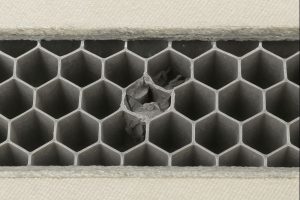 X-ray inspection identifying crushed honeycomb cells within a bonded aerospace panel.