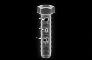 X-ray image of a bolt showing inclusions, voids, or internal density issues.